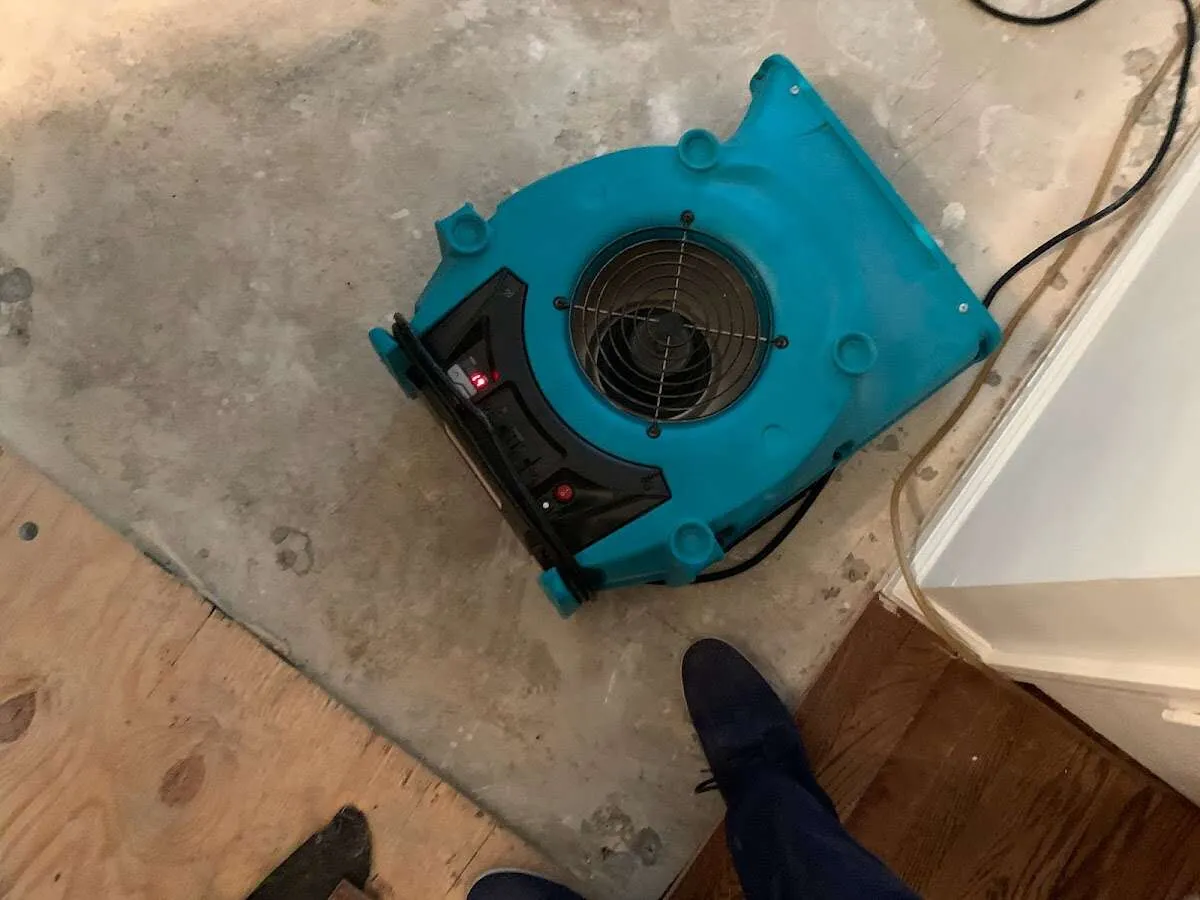 Air mover drying subfloor during Commercial Water Damage Restoration in Eagle Mountain
